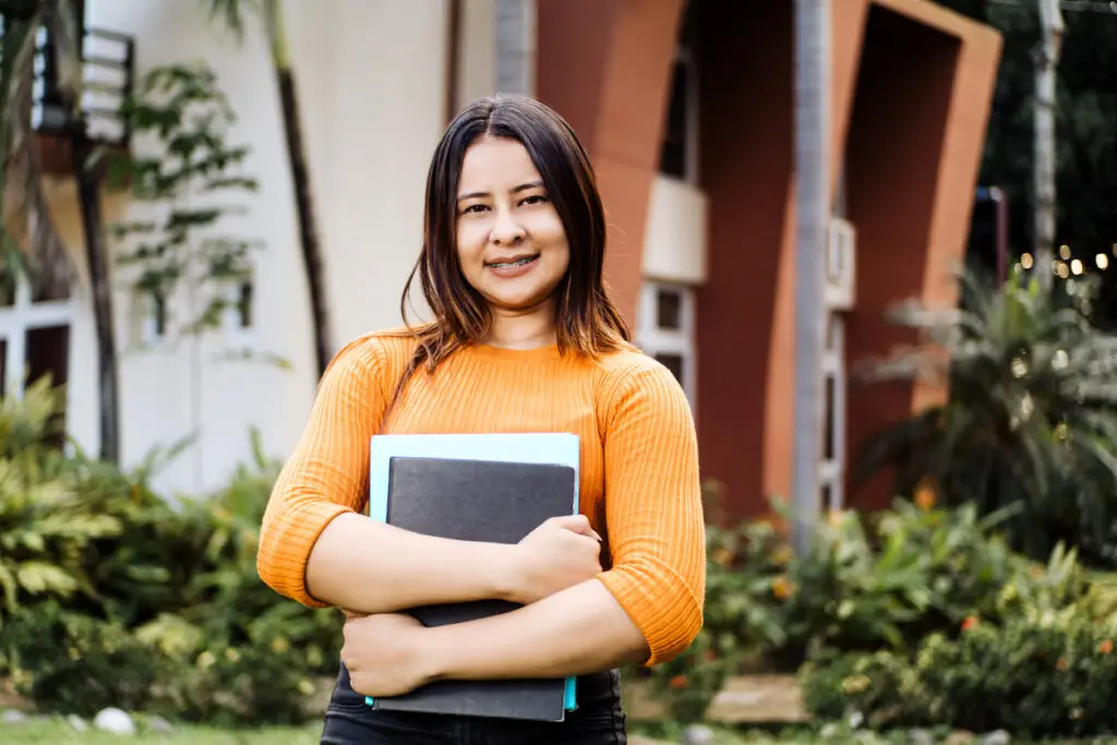 young university student stands outside after scheduling her abortion information consultation in Florida.